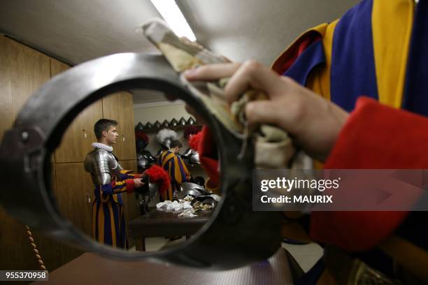 Recruits of the Vatican's elite Swiss Guard check their uniform before the swearing in ceremony for new members at the Cortile di San Damaso at the...