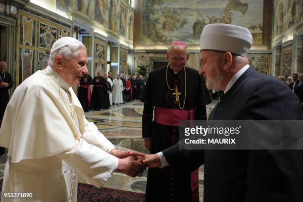 Pope Benedict XVI greets Muslim delegation head Mustafa Ceric , the Grand Mufti of Bosnia - Christians and Muslims must overcome their...