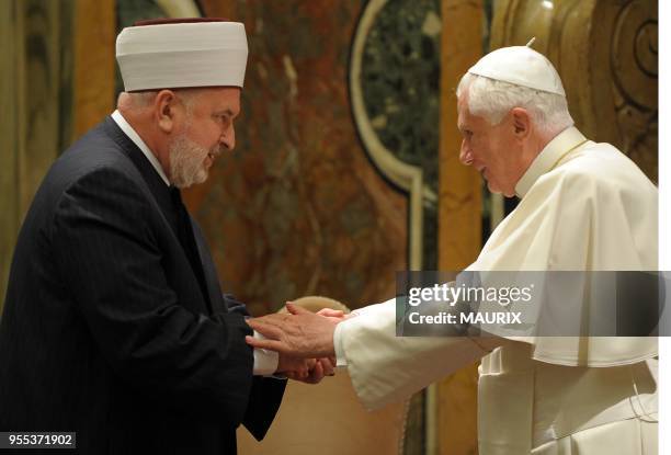 Pope Benedict XVI greets Muslim delegation head Mustafa Ceric , the Grand Mufti of Bosnia - Christians and Muslims must overcome their...