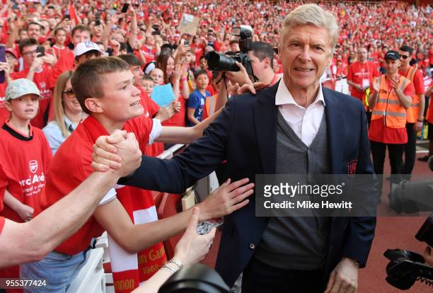 Arsene Wenger, Manager of Arsenal shakes hands with a Arsenal fan after the Premier League match between Arsenal and Burnley at Emirates Stadium on...