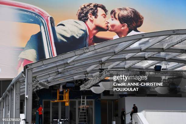 People stand in front of the Palace of Festivals and Conferences on May 6 two days before the opening of the 71th Cannes Film Festival in Cannes,...