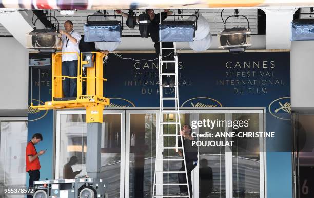 People work in front of the Palace of Festivals and Conferences on May 6 two days before the opening of the 71th Cannes Film Festival in Cannes,...