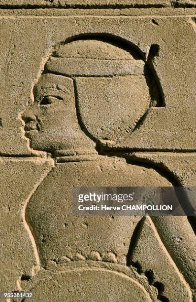 Temple of Amon Re at Karnak. East Thebes. The figure of an African prisoner with a rope around his neck, sculpted in sandstone. Like in the image of...