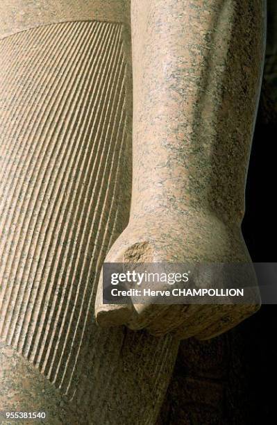 Temple of Luxor. East Thebes. This arm of a granite colossus is very impressive by the power is gives off. The hand is clenched so tightly that the...