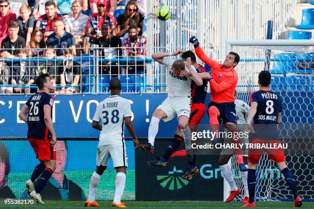 Monaco's Polish defender Kamil Glik vies for the ball with Caen's French defender Damien Da Silva and Caen's French goalkeeper Remy Vercoutre during...