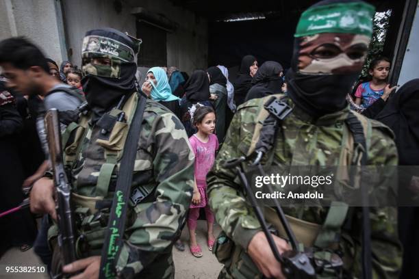 Members of Izz ad-Din al-Qassam Brigades, which is the military wing of the Palestinian Hamas organization, attend the funeral ceremony of Beha...