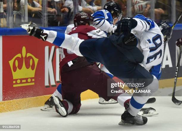 Latvia's Rodrigo Abols falls down next to Finland's Mikko Rantanen during the group B match Latvia vs Finland of the 2018 IIHF Ice Hockey World...