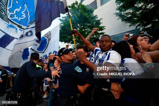 Police stand guard as Porto's supporters wait to greet the team bus outside the Dragao stadium in Porto ahead of the Portuguese league football match...