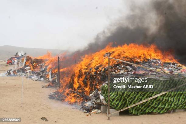 Anti-Narcotics Force officials burn pile of confiscated drugs during ceremony on the occasion of "Anti-Narcotics Day" held at Neelum Point in Karachi...