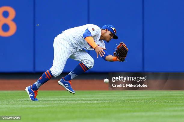 Juan Lagares of the New York Mets is unable to catch a fly ball off the bat of Gerardo Parra of the Colorado Rockies for a error in the fifth inning...