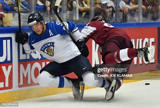 Finland's Mikko Rantanen and Latvia's Kristians Rubins fall down during the group B match Latvia vs Finland of the 2018 IIHF Ice Hockey World...