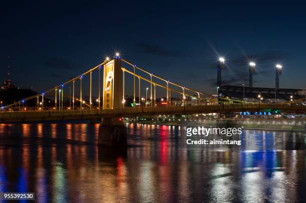 night view of bridge over allegheny river with pnc park in background in pittsburgh - allegheny river stock pictures, royalty-free photos & images