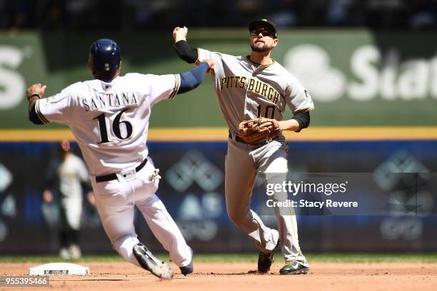 Domingo Santana of the Milwaukee Brewers slides into second base as Jordy Mercer of the Pittsburgh Pirates turns a double play during the second...