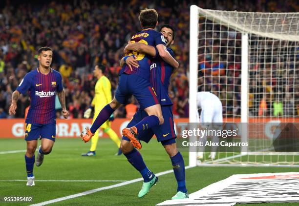 Luis Suarez of Barcelona celebrates with Sergi Roberto of Barcelona as he scores his sides first goal during the La Liga match between Barcelona and...