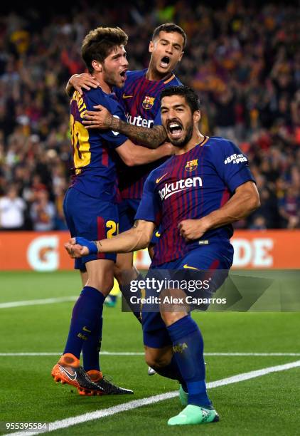 Luis Suarez of Barcelona celebrates with Sergi Roberto and Philippe Coutinho as he scores his sides first goal during the La Liga match between...