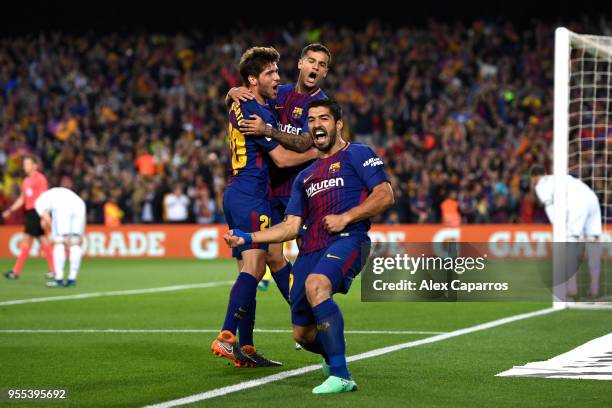 Luis Suarez of Barcelona celebrates with Sergi Roberto and Philippe Coutinho as he scores his sides first goal during the La Liga match between...
