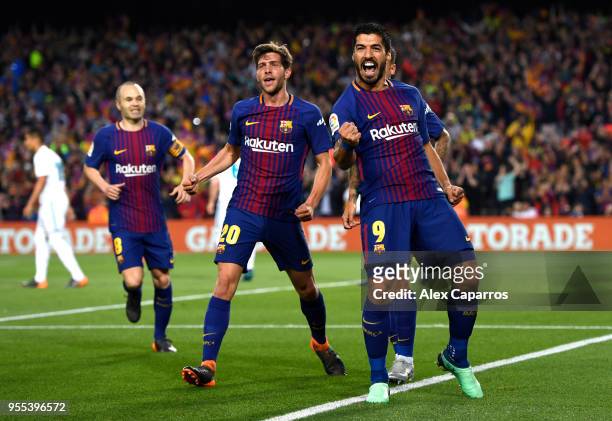 Luis Suarez of Barcelona celebrates with Sergi Roberto of Barcelona as he scores his sides first goal during the La Liga match between Barcelona and...