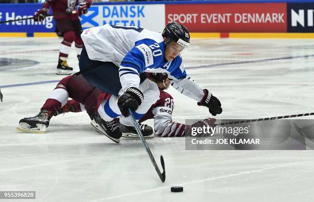 Finland's Sebastian Aho fights for the puck with Latvia's Uvis Baliskis during the group B match Latvia vs Finland of the 2018 IIHF Ice Hockey World...