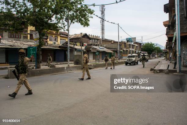 Indian paramilitary troopers patrol the deserted streets during the restrictions imposed by Indian authorities in Srinagar, the summer capital of...