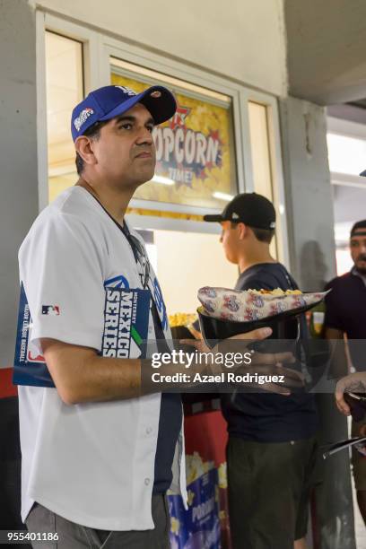 Fan holds popcorn inside a baseball helmet prior the MLB game between the San Diego Padres and the Los Angeles Dodgers at Estadio de Beisbol...