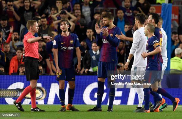 Gerard Pique of Barcelona reacts as Alejandro Jose Hernandez Hernandez shows a red card to Sergi Roberto of Barcelona as he is sent off during the La...