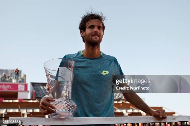 Portuguese tennis player Joao Sousa holds his trophy during an award ceremony after winning the Millennium Estoril Open ATP Singles tournament in...