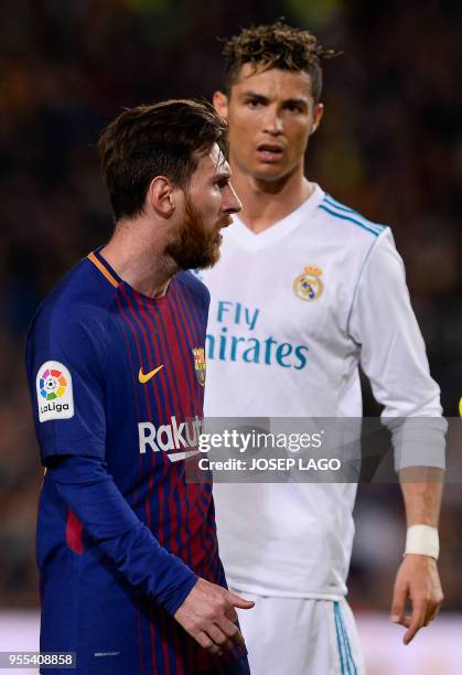 Real Madrid's Portuguese forward Cristiano Ronaldo looks at Barcelona's Argentinian forward Lionel Messi during the Spanish league football match...