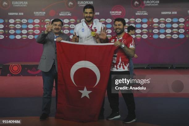 Turkish wrestler Taha Akgul poses during a medal ceremony after he won the gold medal in European Wrestling Championship after beating his Georgian...