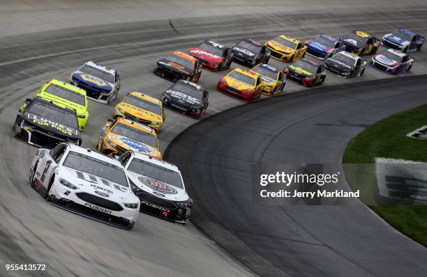 Brad Keselowski, driver of the Miller Lite Ford, leads a pack of cars during the Monster Energy NASCAR Cup Series AAA 400 Drive for Autism at Dover...