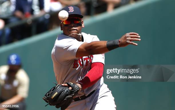 Rafael Devers of the Boston Red Sox throws to first base after fielding a ball off the bat of Ronald Guzman of the Texas Rangers during the second...