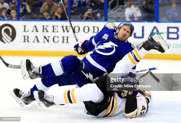 Ryan McDonagh of the Tampa Bay Lightning and Danton Heinen of the Boston Bruins collide during Game Five of the Eastern Conference Second Round...