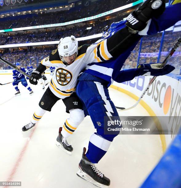 Tim Schaller of the Boston Bruins and Mikhail Sergachev of the Tampa Bay Lightning fight for the puck during Game Five of the Eastern Conference...