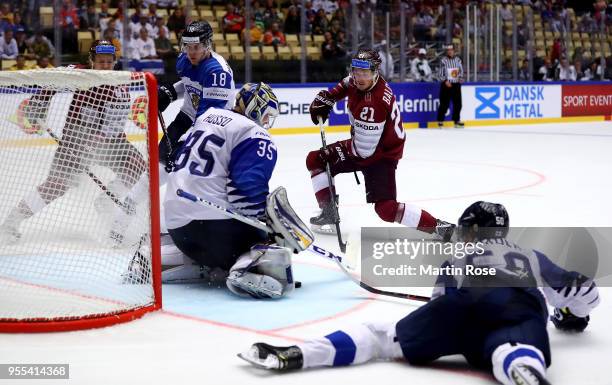 Rudolfs Balcers of Latvia fails to score over Ville Husso, goaltender of Finland battle during the 2018 IIHF Ice Hockey World Championship group...