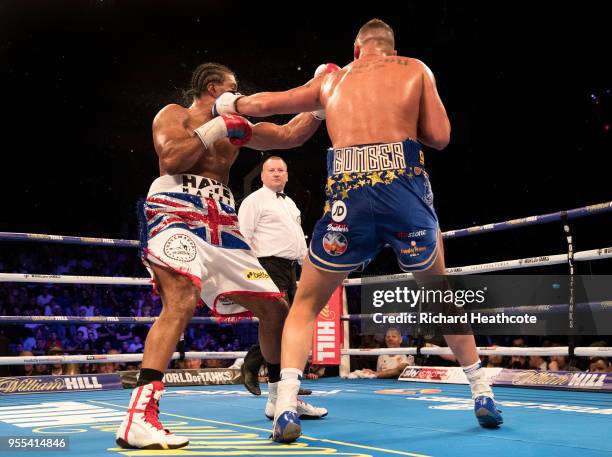 Tony Bellew delivers a left hook to floor David Haye in the 5th round during the Heavyweight contest between Tony Bellew and David Haye at The O2...