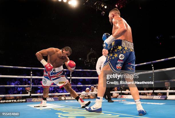 Tony Bellew delivers a left hook to floor David Haye in the 5th round during the Heavyweight contest between Tony Bellew and David Haye at The O2...