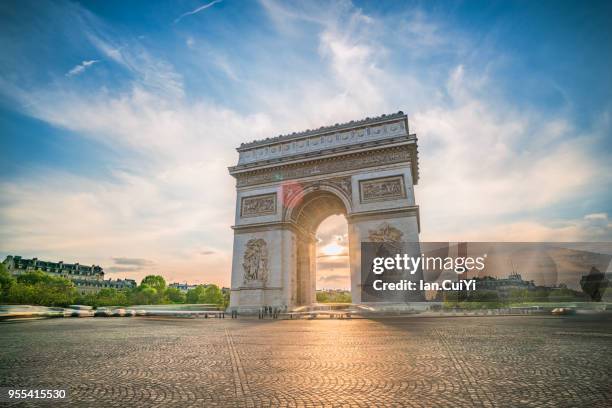 view of arc de triomphe in paris at sunset. - avenue stock pictures, royalty-free photos & images