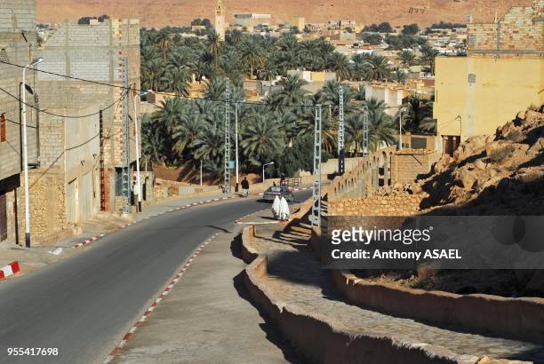 High angle view of vehicle moving on road by houses in city, Melika, Algeria.