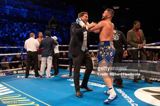 Tony Bellew celebrates victory over David Haye with promotor Eddie Hearn during the Heavyweight contest between Tony Bellew and David Haye at The O2...
