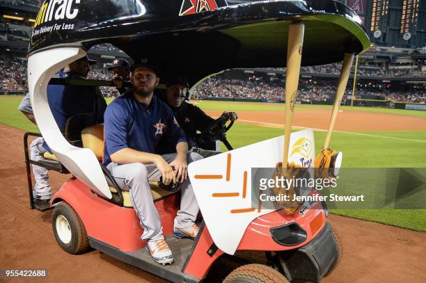 Chris Devenski of the Houston Astros takes a ride to the bullpen in the bullpen cart prior to the MLB game between the Houston Astros and Arizona...