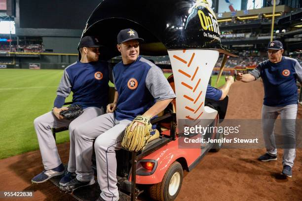 Collin McHugh and Brad Peacock of the Houston Astros take a ride in the bullpen cart prior to the MLB game against the Arizona Diamondbacks at Chase...