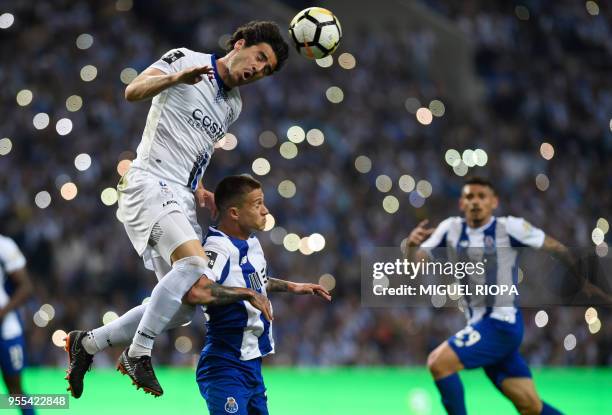 Feirense's Mexican defender Antonio Briseno heads the ball over Porto's Brazilian midfielder Otavio during the Portuguese league football match...