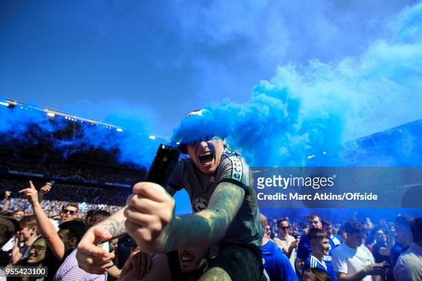 Cardiff City fan celebrates promotion holding a smoke bomb during the Sky Bet Championship match between Cardiff City and Reading at Cardiff City...