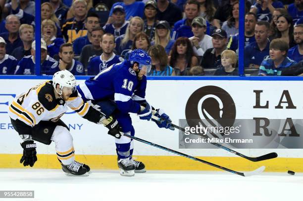Miller of the Tampa Bay Lightning and Kevan Miller of the Boston Bruins fight for the puck during Game Five of the Eastern Conference Second Round...
