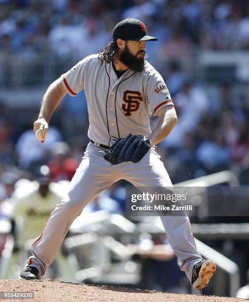 Pitcher Cory Gearrin of the San Francisco Giants throws a pitch in the sixth inning during the game against the Atlanta Braves at SunTrust Park on...