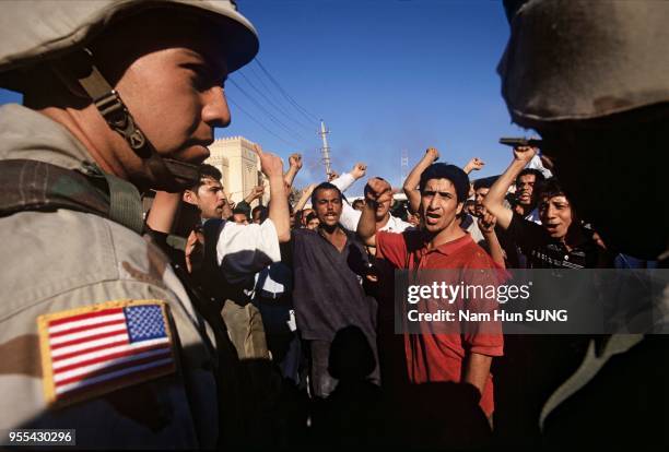 American soldiers are keeping Baghdad residents from coming near a burning gas station. The fire began accidentally by inhabitants shooting into the...