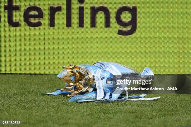 Manchester City players knock the Premier League Trophy off the plinth during the championship celebrations after the Premier League match between...