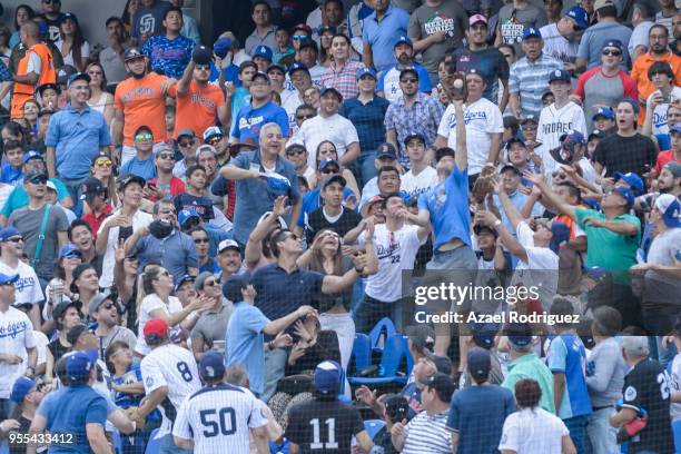 Fan catches a ball during the MLB game between the San Diego Padres and the Los Angeles Dodgers on May 6, 2018 at Estadio de Beisbol Monterrey in...