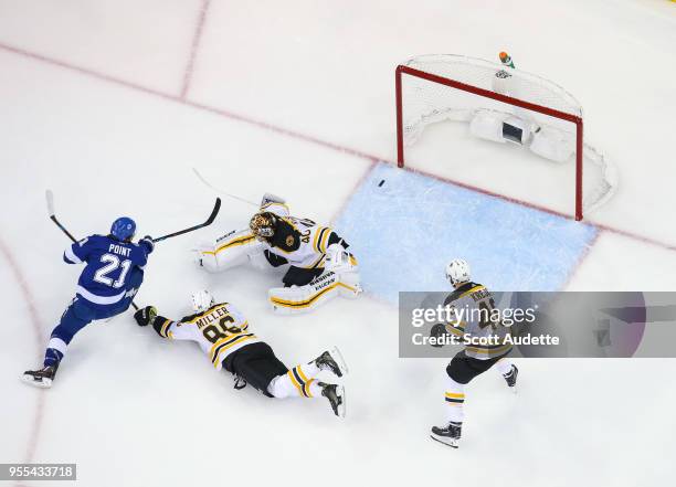 Brayden Point of the Tampa Bay Lightning shoots the puck for a goal against Kevan Miller, David Krejci, and goalie Tuukka Rask of the Boston Bruins...