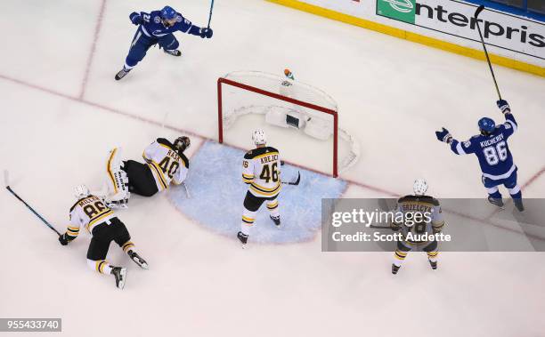 Brayden Point of the Tampa Bay Lightning shoots the puck for a goal against Kevan Miller, David Krejci, and goalie Tuukka Rask of the Boston Bruins...