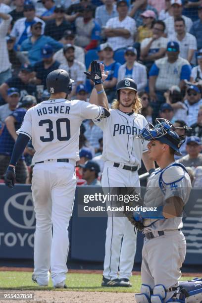 Eric Hosmer of San Diego Padres celebrates with teammate Travis Jankowski after hitting a two home run in the fifth inning during the MLB game...